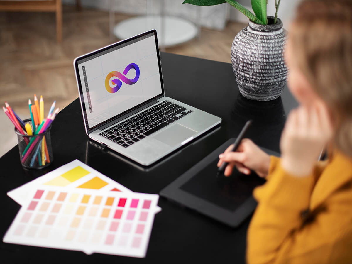 female-logo-designer-working-her-tablet-connected-laptop